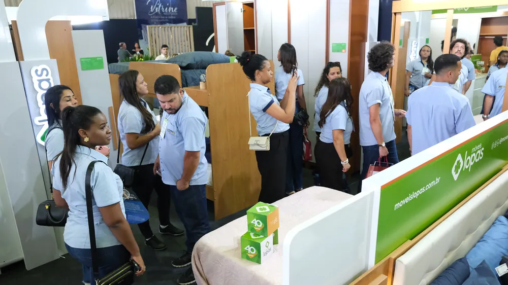 Estande montado de uma indústria do polo, com a equipe recebendo lojistas na FEMUR 2026